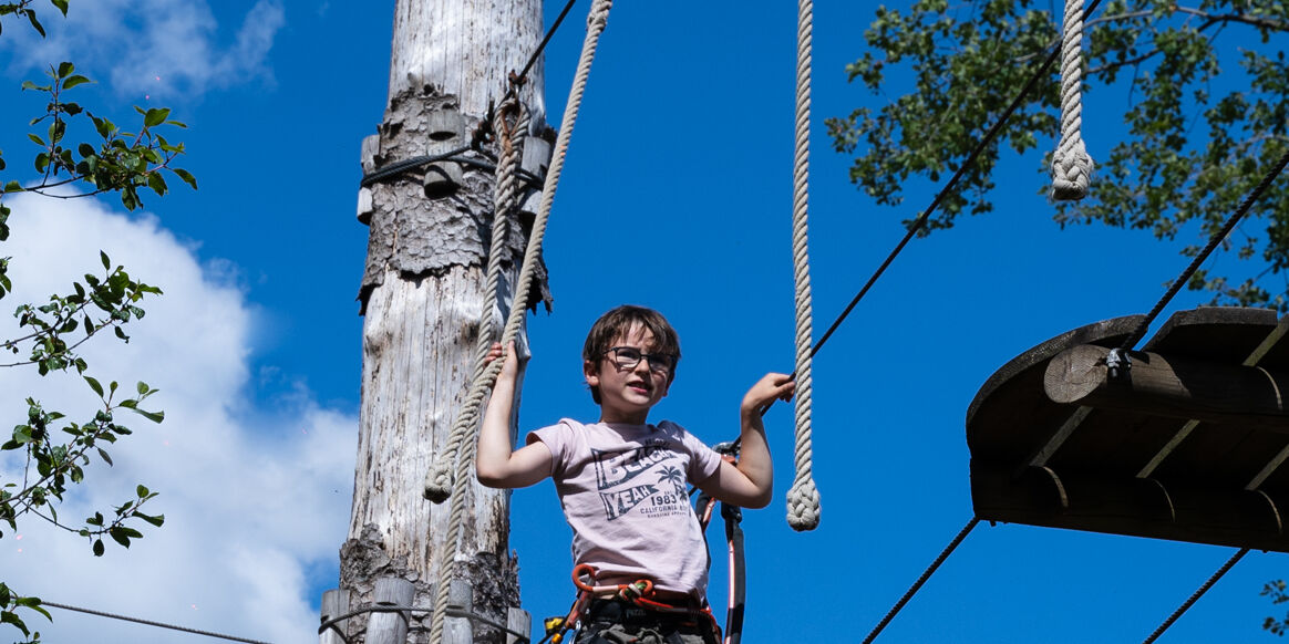 Enfant traversant une des passerelles de l'accrobranche Enfant traversant une des passerelles de l'accrobranche