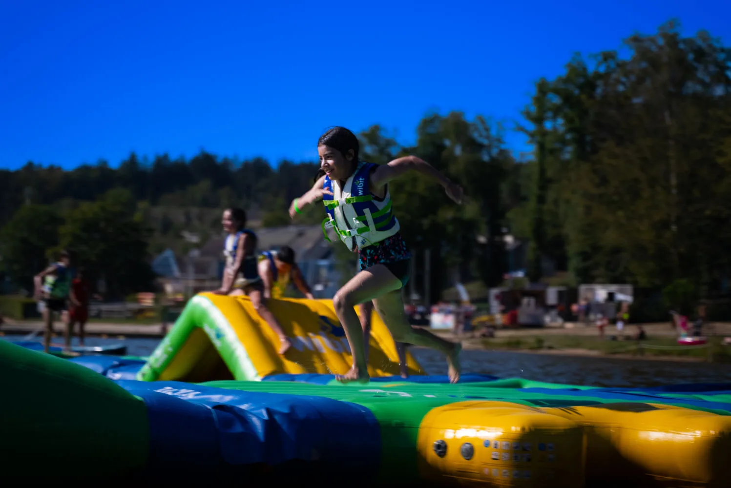 Child running on the “Curve” module at Wisplash, Lac des Vieilles-Forges